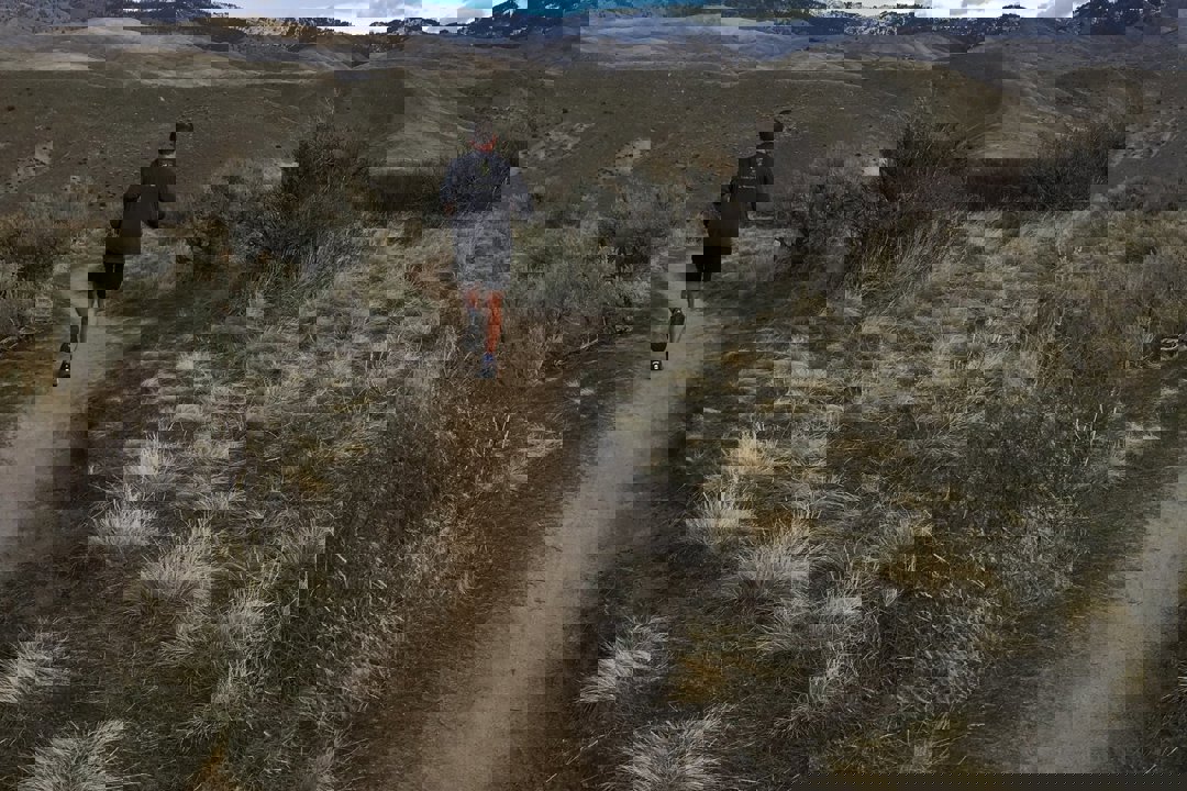 Runner on trail in foothills.