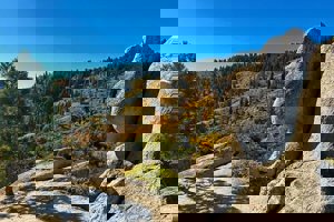Fall trees change color in the background of rock outcropping on Around the Mountain Trail.